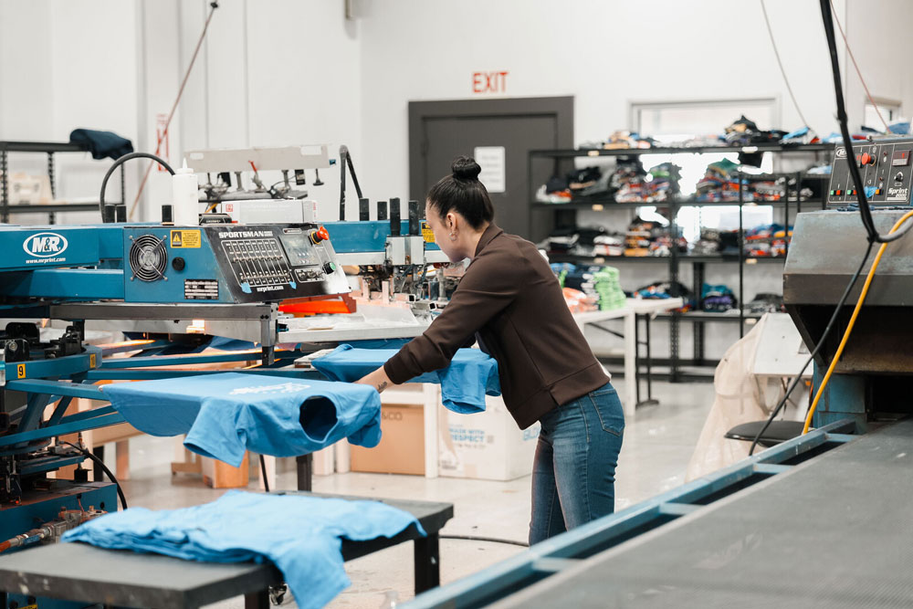 Custom apparel printing in progress at the Vivid Customs production facility